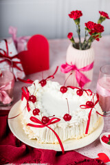 heart-shaped tiramisu cake with white cream, coffee glaze, cocktail cherry, red decorative ribbons, Valentine's Day cake, red flowers in a vase, tiramisu with cherry, mousse cake