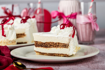 heart-shaped tiramisu cake with white cream in a cut on a white plate, cocktail cherry, red ribbons, Valentine's Day cake, tiramisu with cherry, mousse cake, birthday sweets