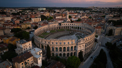 Flying above historic city of Pula , historic Roman amphitheatre of Pula aerial view, tourism in Croatia