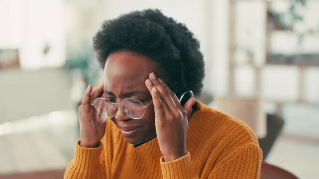 Frustrated, black woman and headache with headset for stress, difficult customers or burnout in home office. Female person, pain or migraine with fatigue or anxiety in remote work for target deadline