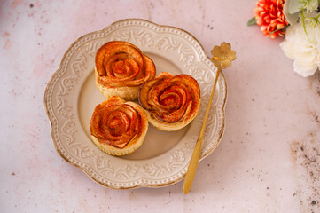 Apple roses Puff pastry sprinkled with red dry powdered strawberry. Romantic Dessert for...
