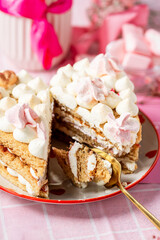 bento cake in the shape of a heart for two lovers, honey cake with buttercream and marshmallows, cake on a plate with hearts, pink gypsophila in a vase with a ribbon, light background, cake on a pink 