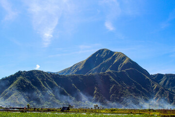 Mountain range with a foggy mist rising from the valley below