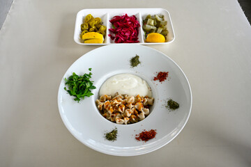 Manti Turkish Ravioli Kayseri with yogurt and chili sauce.