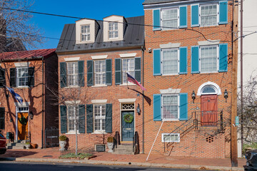 row of colonial-style brick townhouses in the historic district of Alexandria, near Washington.