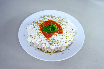 Manti Turkish Ravioli Kayseri with yogurt and chili sauce.