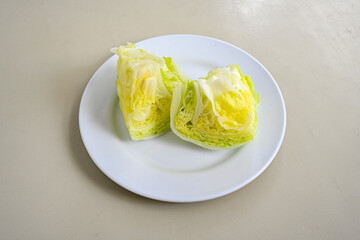Whole and cut fresh green iceberg lettuces isolated on white