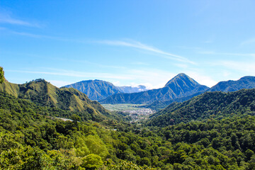 Fototapeta premium Beautiful Sembalun Hill, Lombok Indonesia range with a city in the distance