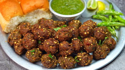 Meat balls, Kebab on a silver plate with soft buns, vibrant red and green sauce, and crispy fried chilies. A popular dish in Middle Eastern, South Asian, and North African, Ramadan and Eid. 