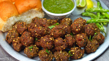 Meat balls, Kebab on a silver plate with soft buns, vibrant red and green sauce, and crispy fried chilies. A popular dish in Middle Eastern, South Asian, and North African, Ramadan and Eid. 