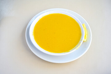 Lentil ( mercimek corbasi ) soup with melted butter and red pepper sauce. Limon ve soslu mercimek corba.