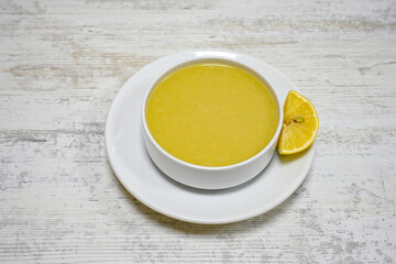 Lentil ( mercimek corbasi ) soup with melted butter and red pepper sauce. Limon ve soslu mercimek corba.