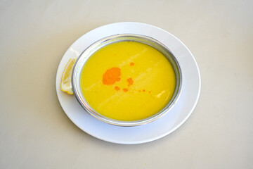Lentil ( mercimek corbasi ) soup with melted butter and red pepper sauce. Limon ve soslu mercimek corba.
