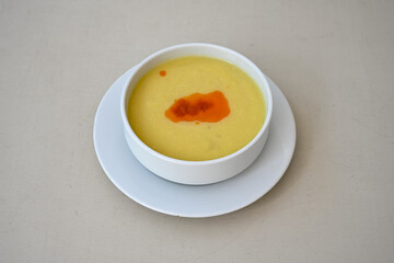 Lentil ( mercimek corbasi ) soup with melted butter and red pepper sauce. Limon ve soslu mercimek corba.