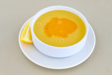 Lentil ( mercimek corbasi ) soup with melted butter and red pepper sauce. Limon ve soslu mercimek corba.