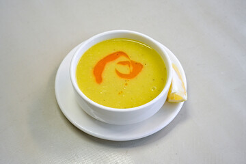 Lentil ( mercimek corbasi ) soup with melted butter and red pepper sauce. Limon ve soslu mercimek corba.