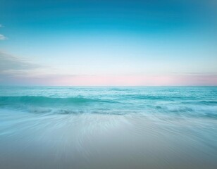 Fototapeta premium Tranquility at the Water's Edge: A breathtaking seascape with soft, pastel hues of blue and pink paints the horizon, as gentle waves lap onto the pristine sandy shore.