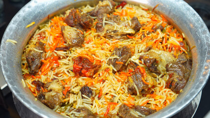 Authentic Mutton Biryani, a royal dish from Indian and Mughlai cuisine, made made with tender goat or lamb meat, basmati rice, and aromatic spices A famous Indian, Pakistani, and Hyderabadi delicacy.