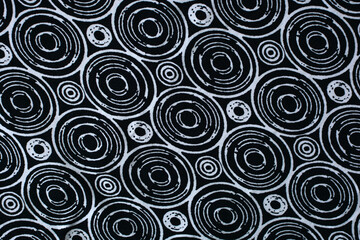 black background with white circles. texture of black fabric with geometric patterns.