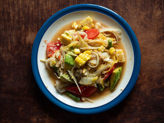 SOM TUM, Thai spicy green papaya salad, mixed with corn and avocado