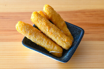 Delicious crispy cheese sticks with mozzarella, salt and spices, breaded and fried in oil. Fast food, takeaway