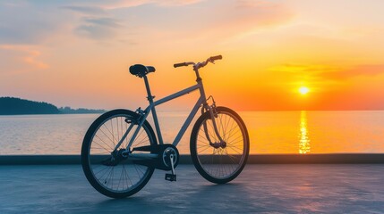 Fototapeta premium Bicycle by the Sea at Sunset Over Calm Water