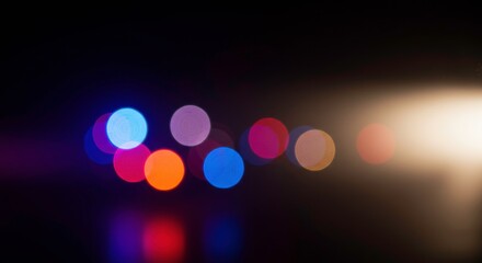 Urban Night Lights: Abstract bokeh effect of colorful city lights at night, creating a vibrant and dynamic visual, perfect for backgrounds and designs. 
