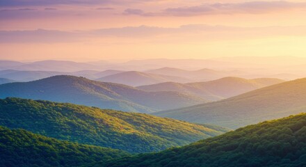Obraz premium Mountain Majesty at Sunrise: Serene landscape photography captures rolling mountain ranges bathed in the warm, golden light of sunrise. Layers of hills extend to the horizon.