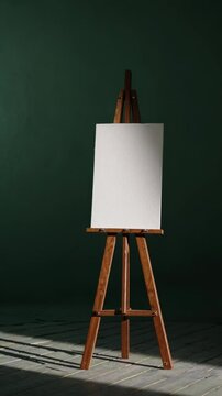 A vintage wooden easel holding a textured blank canvas against a rich green artistic backdrop.