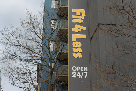 exterior projecting sign of Fit4Less, a gym, located at 21 McCaul St in Toronto, Canada