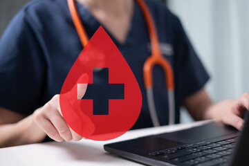 Professional health care worker doctor physician holding blood icon for blood donation concept