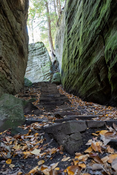 Stone stairs climbing between two mossy rock faces