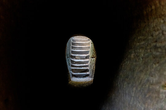 Stone stairs through a dark tunnel
