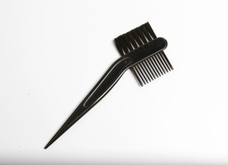 Black plastic 2-in-1 hair dye applicator brush and comb, commonly used for applying hair color