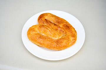 Turkish style meat stuffed filo dough borek served kol boregi. Cheese and minced pie are sliced on a marble background.  Avci boregi.Turkish name: Kol Boregi. Kiymali, peynirli su boregi.