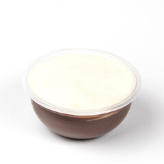 A creamy layer of chocolate pudding dessert with a smooth whipped cream topping is showcased in a clear bowl, ready to be enjoyed