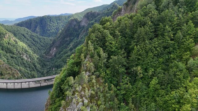 Drone  fling around Vidraru dam in Romania. Mountain landscape