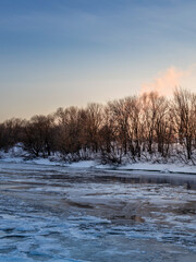 Snowy landscape with a river and trees