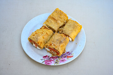 Freshly baked appetizing Turkish tortillas - Gozleme with spinach, cheese  on a white board. Space for text. Handmade Turkish traditional pastries. Ispanakli, otlu peynirli gozleme. Tahinli Katmer