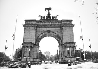 grand army plaza arch view covered in snow during winter at entrance to prospect park in brooklyn...