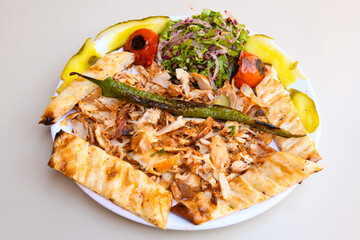 Lavash zurna doner kebab ( zurna  durum )  or shawarma sliced in plate isolated.  hatay usulu tavuk Et doner durum. Gobit ekmek arasi doner. Pilavustu iskender doner kebap. 