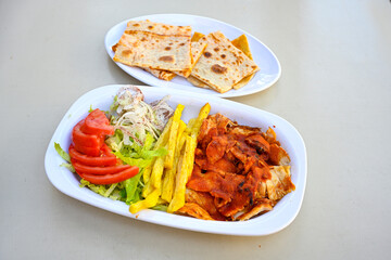 Lavash zurna doner kebab ( zurna  durum )  or shawarma sliced in plate isolated.  hatay usulu tavuk Et doner durum. Gobit ekmek arasi doner. Pilavustu iskender doner kebap. 