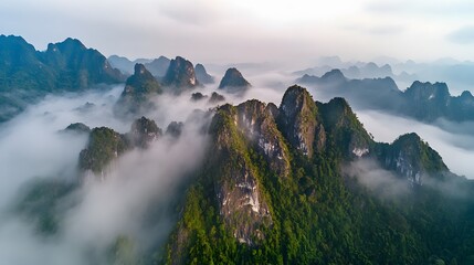 Lush mountain landscape shrouded in mist, serene natural beauty highlighting rugged peaks, perfect for travel or adventure themes.
