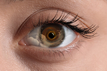 Hypnosis. Hypnotic spiral and clouds in woman's eye, closeup