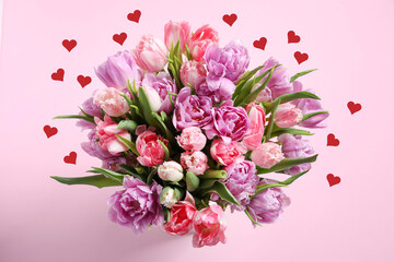 Bouquet of beautiful tulips and red paper hearts on pink background, top view