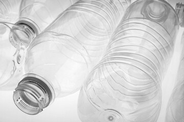 Empty plastic bottles on white background, closeup