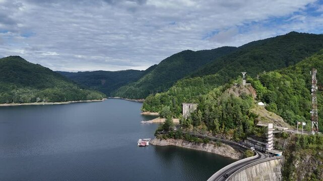Lake and Mountain. Flying along the lake. Drone footage fling around Vidraru dam in Romania