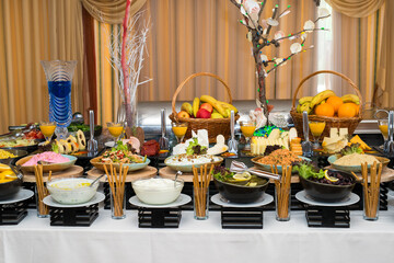 Snacks for the holiday, catering. Various snacks. Assortment of salads and buffet dishes. Meat, fish, cheese, salads, fruits and vegetables, sauces and canapes for celebrating a festive event.