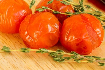 Glistening Sun-Dried Tomatoes & Thyme: Close-Up Shot on Wooden Board for Mediterranean Cuisine, Healthy Eating & Food Blog Projects