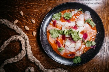 Creative Fish Sashimi with Herbs and Dressing, Top View - Exotic fish on a plate for dinner